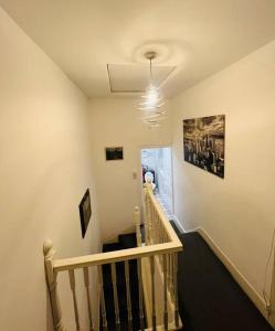 a hallway with a stairway with a staircase at 4 Bedroom House, Central City Location in Newcastle upon Tyne