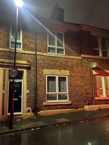 a brick building with a street light in front of it at 4 Bedroom House, Central City Location in Newcastle upon Tyne