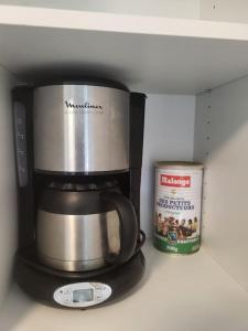 a coffeemaker with a coffee pot and a can in a refrigerator at Studio 5min aéroport d'Orly 2 lits in Athis-Mons