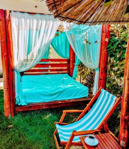 a bed and a chair and a bed and a table at Villa Saturea in Boljevac