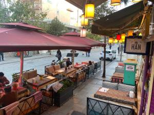 a group of people sitting at tables on a street at The Han in Istanbul