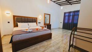 a bedroom with a large bed in a room at Weligama Bay House in Weligama