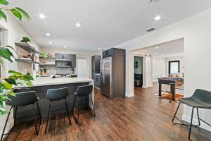 cocina con barra con sillas y mesa en Luxury Getaway with Retreat Heated pool and Jacuzzi L31, en Miami