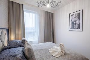 Katil atau katil-katil dalam bilik di 01 Gdynia Premium - Apartament z Siłownią i Parkingiem dla 4os