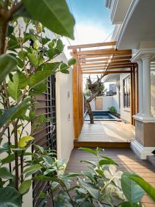 an external view of a house with a porch with plants at Hening Pool Residence in Purwokerto