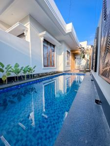 a swimming pool in the middle of a house at Hening Pool Residence in Purwokerto