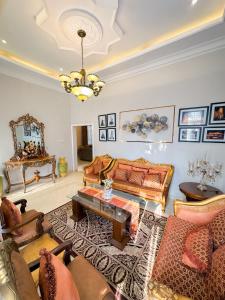 a living room with a couch and a table at Hening Pool Residence in Purwokerto