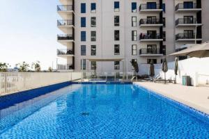 a swimming pool in front of a building at Full Canal View Apartment at Yas Island- Brand New in Abu Dhabi
