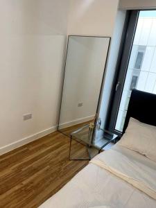a bedroom with a bed and a glass table at Cozie 1 BR apartment in Manchester