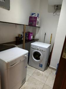 a washing machine and a washer in a kitchen at Masaki - 2 Bedroom Apartment in Dar es Salaam