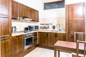 a kitchen with wooden cabinets and a wooden table at Vila Wendy in Sinaia