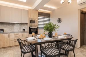 a kitchen and dining room with a table and chairs at Lazai Villa in Zakynthos