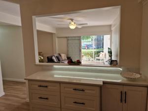 a kitchen with a large mirror over a counter at 2 Bed, parking, gated, modern in Saint Augustine