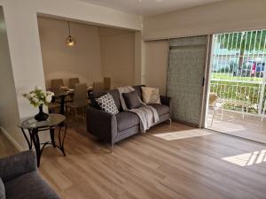 a living room with a couch and a table at 2 Bed, parking, gated, modern in Saint Augustine