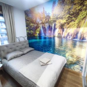 a bedroom with a waterfall mural on the wall at Duki New Belgrade in Belgrade