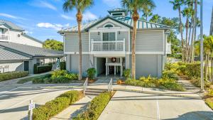 a house with palm trees in front of it at Bayside Escape - 1345 in Siesta Key