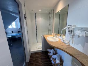 a bathroom with a sink and a shower at Mosaikhotel in Saint-Jean-de-Luz