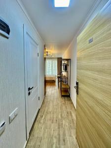 a hallway with a door leading to a room at Orbi Palace Hotel Bakuriani in Bakuriani