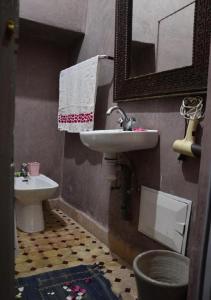 a bathroom with a sink and a toilet at RIAD DAR WINK in Marrakesh