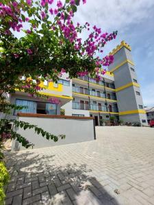 a building with purple flowers in front of it at Pousada Castelo do Rei in Penha