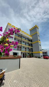 a large building with purple flowers in front of it at Pousada Castelo do Rei in Penha