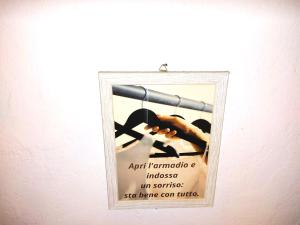 a poster on a wall with a hand holding a telescope at Confortevole Appartamento Il Sorriso piano terra ingresso e parcheggio indipendente per una tranquilla privacy in Lugo