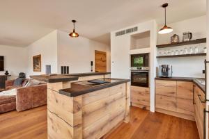 a kitchen with white walls and wooden countertops at Sunshine Apartment Wood'n Rustic in Garmisch-Partenkirchen