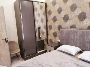 a bedroom with a bed and a large mirror at Luxury new very beautyfull Apartment in Yerevan