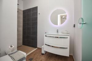 a bathroom with a sink and a mirror at Ocean Island Villa in Achlia