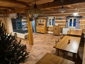 a dining room with wooden floors and wooden tables at Boutique Cottage Tkalcovna in Rokytnice nad Jizerou