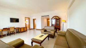 a living room with a couch and a table at Hotel Sor in Phnom Penh