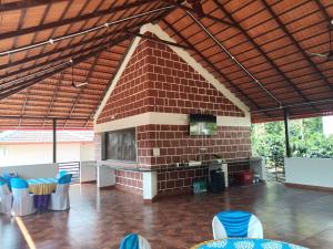 a large brick building with blue chairs in a room at Coffee Country Homestay in Chikmagalūr