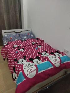 a bed with hello kitty comforter with hearts on it at Hurghada City Apartment 3 in Hurghada
