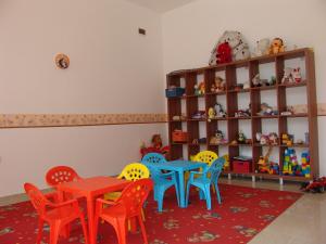 a room with a table and chairs and a shelf at Apart Hotel Efir in Sunny Beach