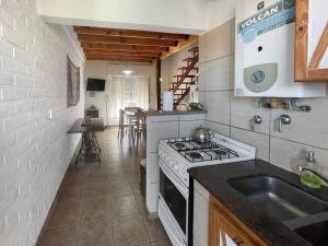 uma cozinha com um fogão e um lavatório em Complejo Hermoseños - by Me Nomad em Monte Hermoso