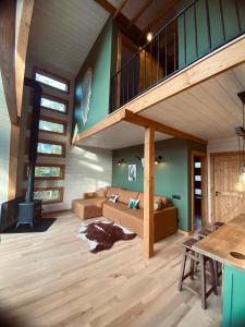 a living room with a staircase and a couch at The Sunset Cabin будиночок з Чаном in Zhuraky