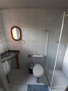 ein kleines Bad mit WC und Waschbecken in der Unterkunft casa do morro linda vista para ate 08 pessoas in Imbituba