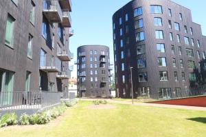 two tall buildings with a lawn between them at Aatrium Kinnisvara Riia str 22 apartment 6th floor in Tartu