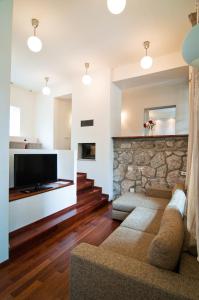 a living room with a couch and a stone wall at Vila Wendy in Sinaia