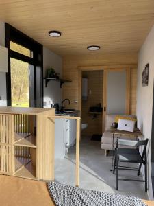 a room with a kitchen with a table and a couch at Tatry Panorama House in Zuberec