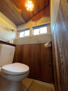 a small bathroom with a toilet and a window at ギャラリー宿　INNAHOUSE ANDAGALLERY in Murotsu
