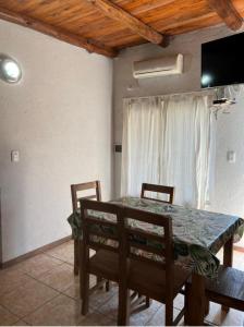a dining room with a table and chairs at CÁBAÑAs , S,E,2 in Villa Los Aromos