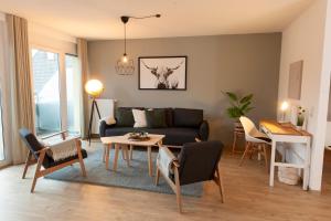 a living room with a couch and a table at FreiTraum Apartments No 2 im Zentrum von Bad Neustadt in Bad Neustadt an der Saale