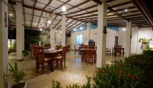 a dining room with a table and chairs at Weleges Place in Hikkaduwa