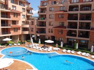 a swimming pool in front of some apartment buildings at Apart Hotel Efir in Sunny Beach