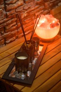 a tray with a candle and a lamp on a table at Ахат- къща за гости in Kyustendil