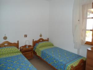Cama ou camas em um quarto em Ville Alba & Azzurra