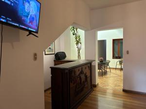 a living room with a flat screen tv on a wall at Habitacion doble vista a la Huaca Miraflores in Lima