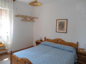 Cama ou camas em um quarto em Ville Alba & Azzurra