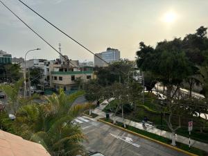 - une vue sur une rue de la ville bordée d'arbres et de bâtiments dans l'établissement Habitacion doble vista a la Huaca Miraflores, à Lima
